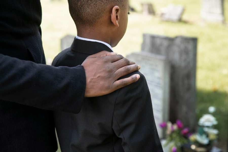 child-visiting-grave-loved-one